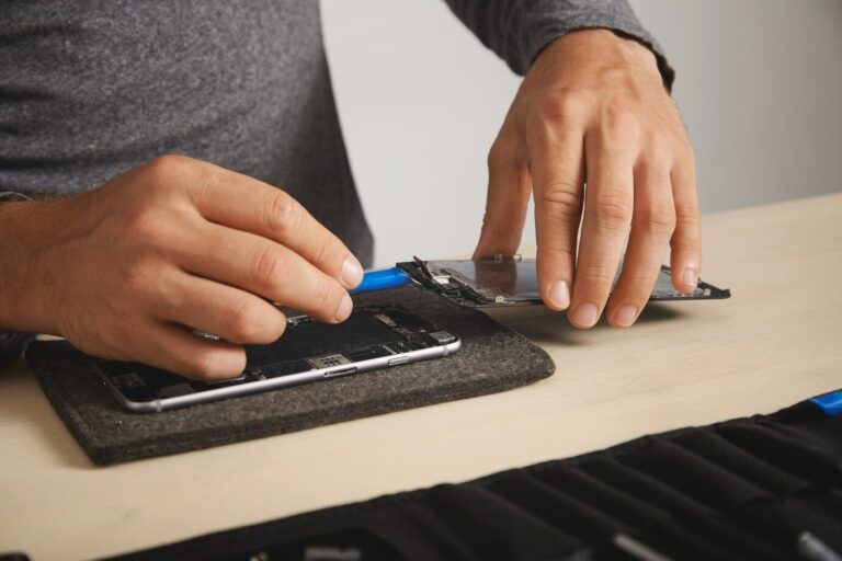 professional-uses-plastic-opener-tool-unplug-screen-cables-from-motherboard-smarthone-deattach-it-replace_346278-1199